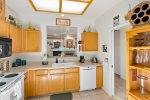 The kitchen is fully equipped with an Electric Oven and Range, Refrigerator, Blender, Coffee Maker, Microwave and Cookware